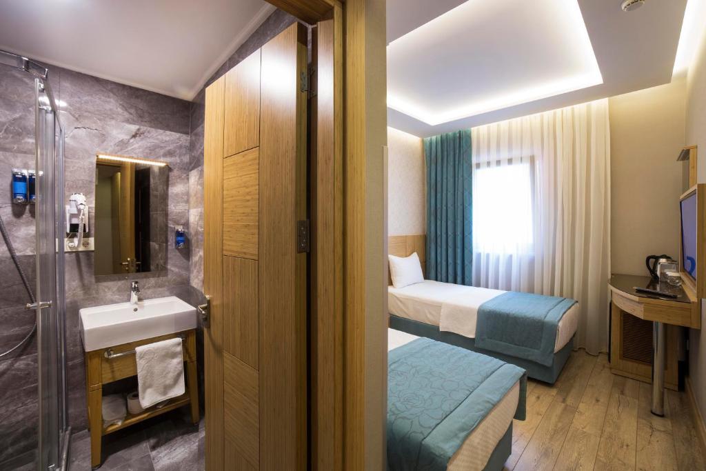 Postel nebo postele na pokoji v ubytování Meretto Hotel LALELİ
