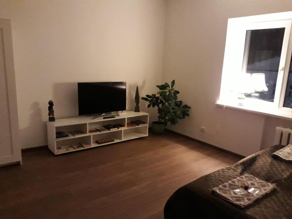 a living room with a flat screen tv on a stand at Tilžės gatvė 144 in Šiauliai