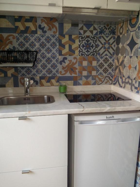 a kitchen with a sink and a counter at Casa da Tia Adozinda in Lisbon