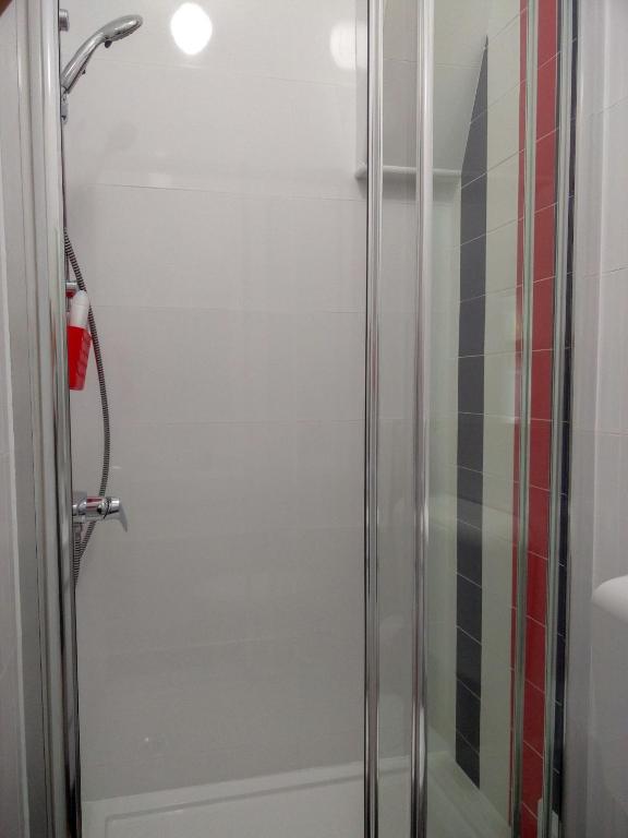 a shower with a glass door in a bathroom at Casa da Tia Adozinda in Lisbon