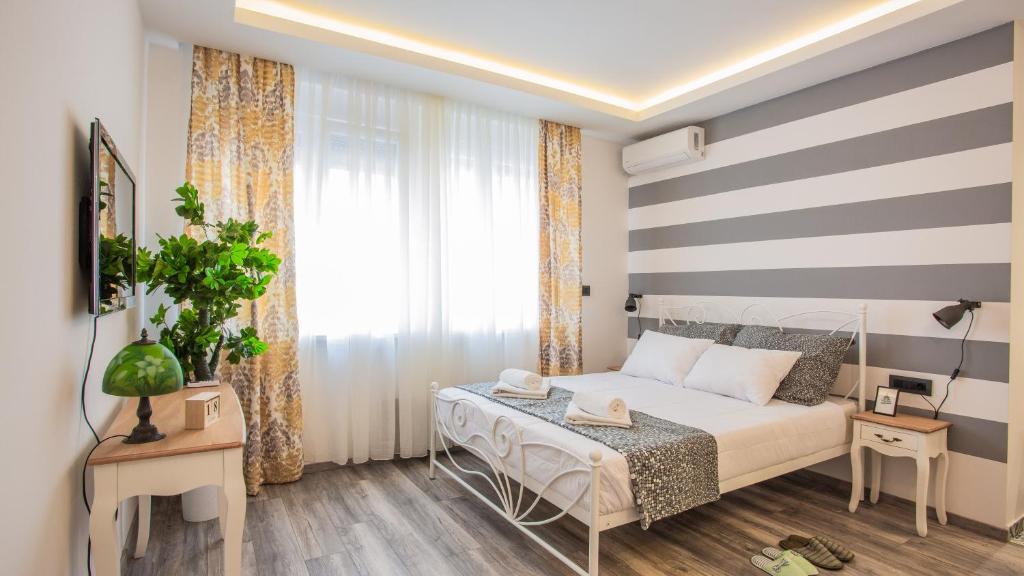 a small bedroom with a bed and a window at Casablanca apartment in Belgrade