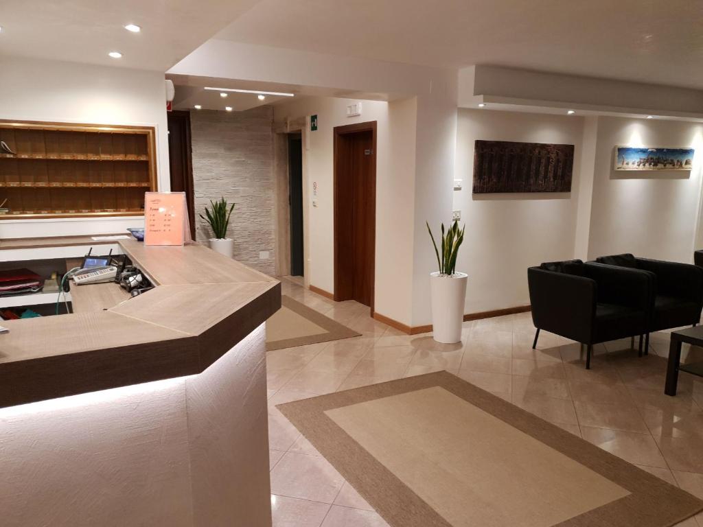 a lobby with a kitchen and a living room at Hotel Rado in Lido di Jesolo