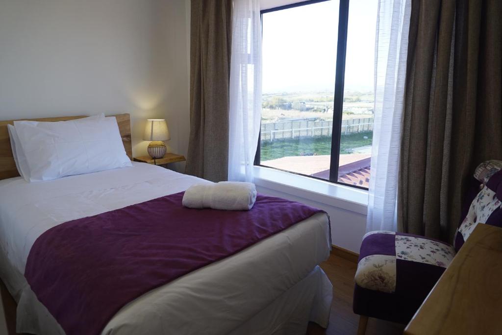 Postel nebo postele na pokoji v ubytování Hostal Doble E Patagonia