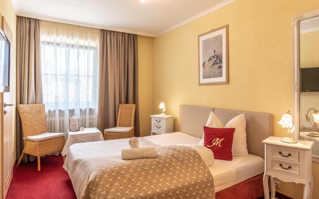 Postel nebo postele na pokoji v ubytování Hotel Mutz Garni