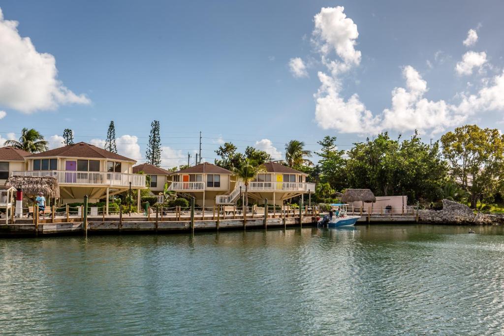 a house on a dock on a body of water at The Reef at Marathon by Capital Vacations in Marathon