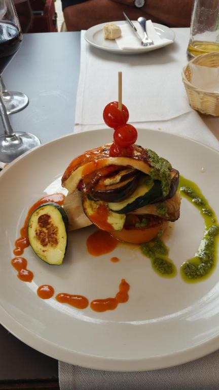 a sandwich on a white plate on a table at Hostal Restaurante El Parador in Alcaracejos