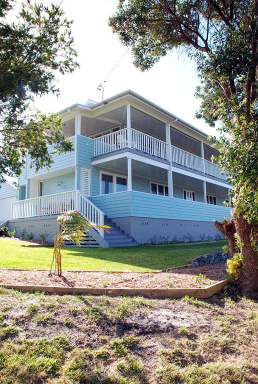 a large blue building with stairs in front of it at Bluebell in Forster