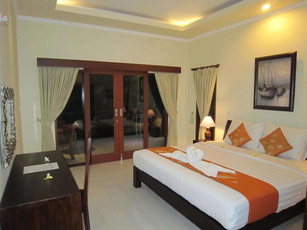 Postel nebo postele na pokoji v ubytování Ketut Kasta Guest House