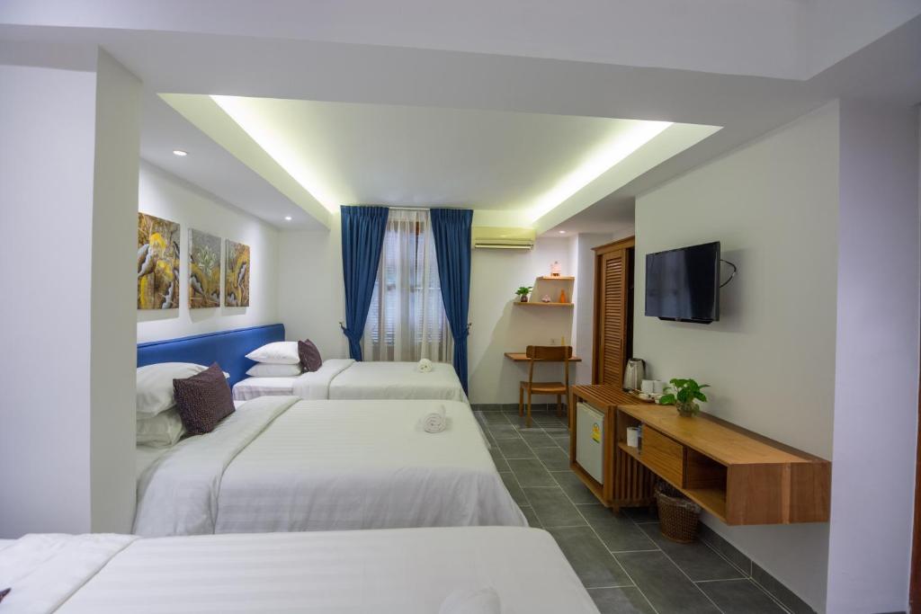 Postel nebo postele na pokoji v ubytování Neth Socheata Hotel