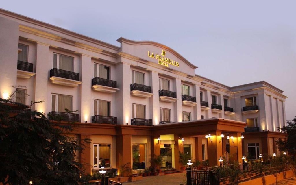 a large white building with a hotel at La Franklin Hotel in Bhubaneshwar