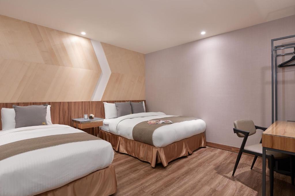 Postel nebo postele na pokoji v ubytování Muzik Hotel - Ximending Xining Branch