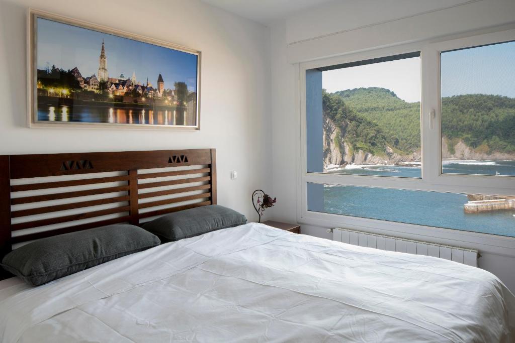 A bed or beds in a room at Armintza Port by Aston Rentals