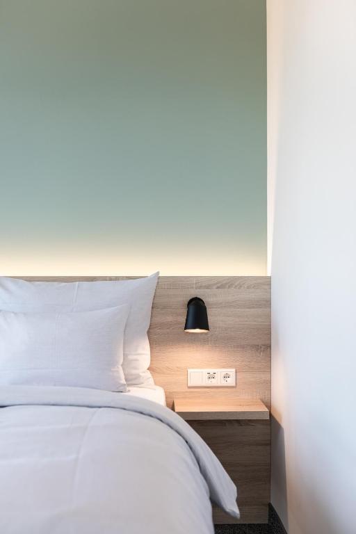 Postel nebo postele na pokoji v ubytování sylc. Apartmenthotel – Serviced Apartments