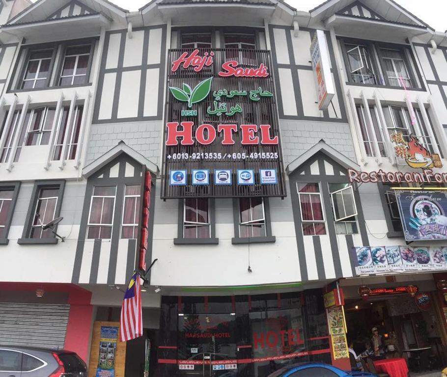a hotel building with a hotel sign on it at Haji Saudi Hotel in Cameron Highlands