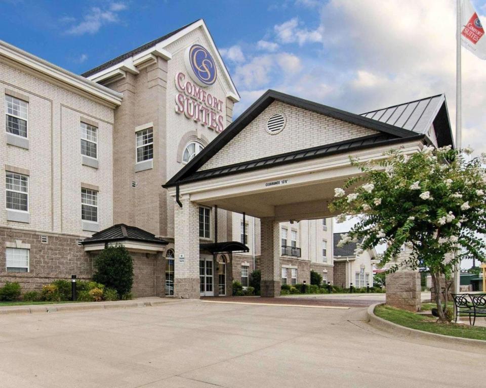 a building with a sign on the front of it at Comfort Suites Conway in Conway