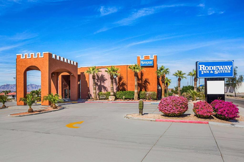 a building with a sign in front of a street at Rodeway Inn & Suites Lake Havasu City in Lake Havasu City