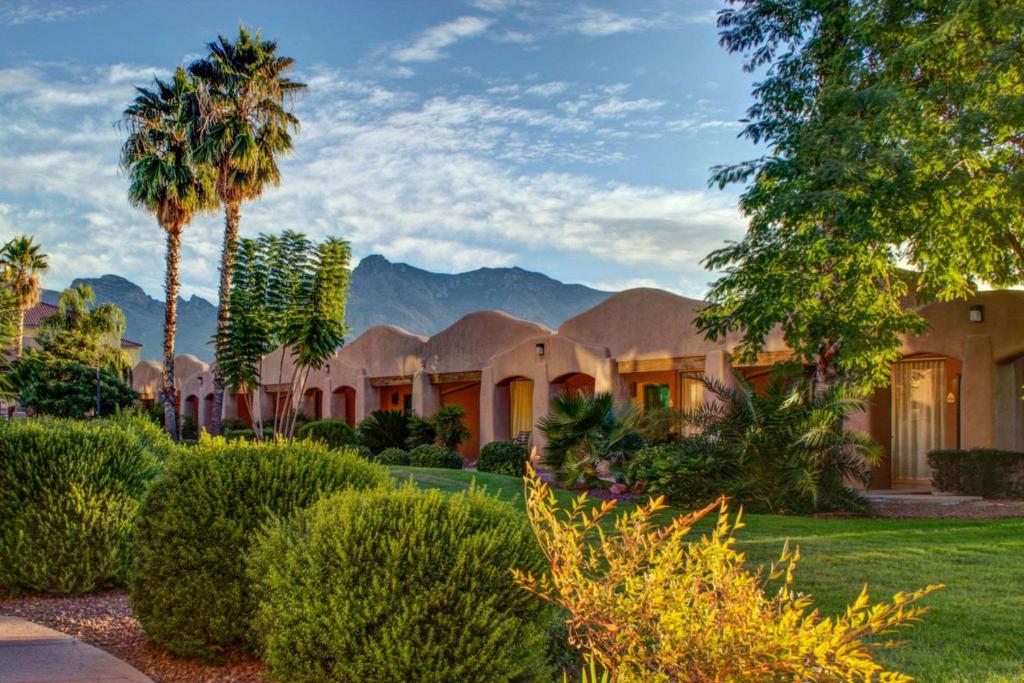 an exterior view of a house with mountains in the background at La Posada Lodge & Casitas, Ascend Hotel Collection in Tucson