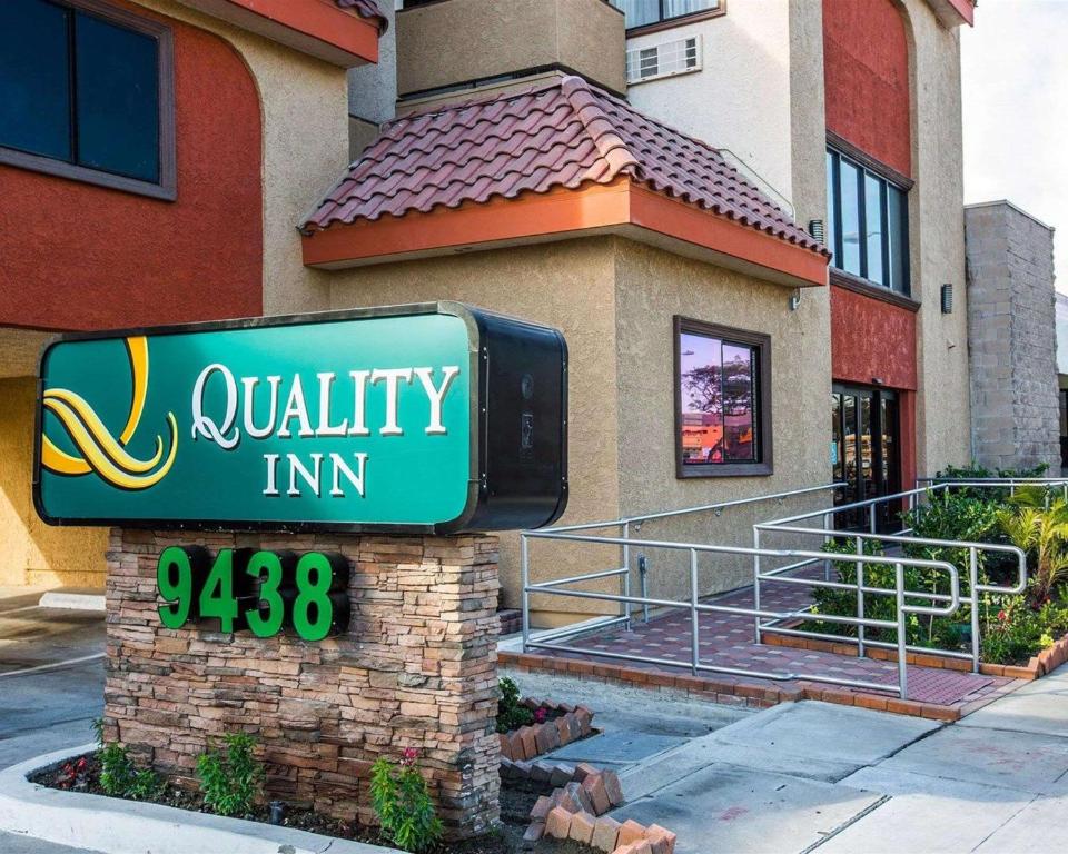 a sign for a loyalty inn in front of a building at Quality Inn Downey in Downey