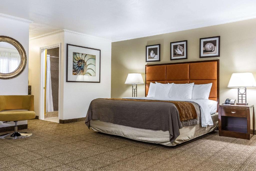 a hotel room with a bed and a chair at Comfort Inn Santa Cruz in Santa Cruz