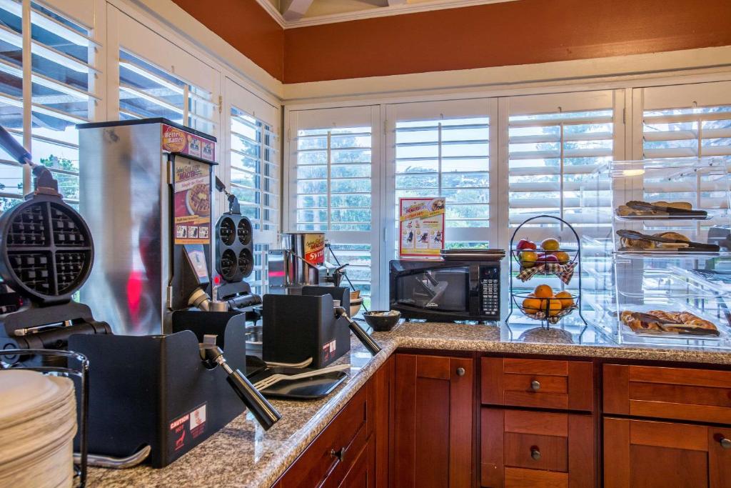 a kitchen with a counter with a microwave at Clarion Collection Wilkie's Inn Pacific Grove - Monterey in Pacific Grove