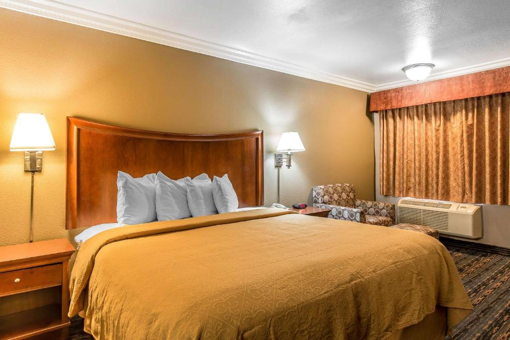 a hotel room with a bed and a chair at Quality Inn Lake Elsinore in Lake Elsinore