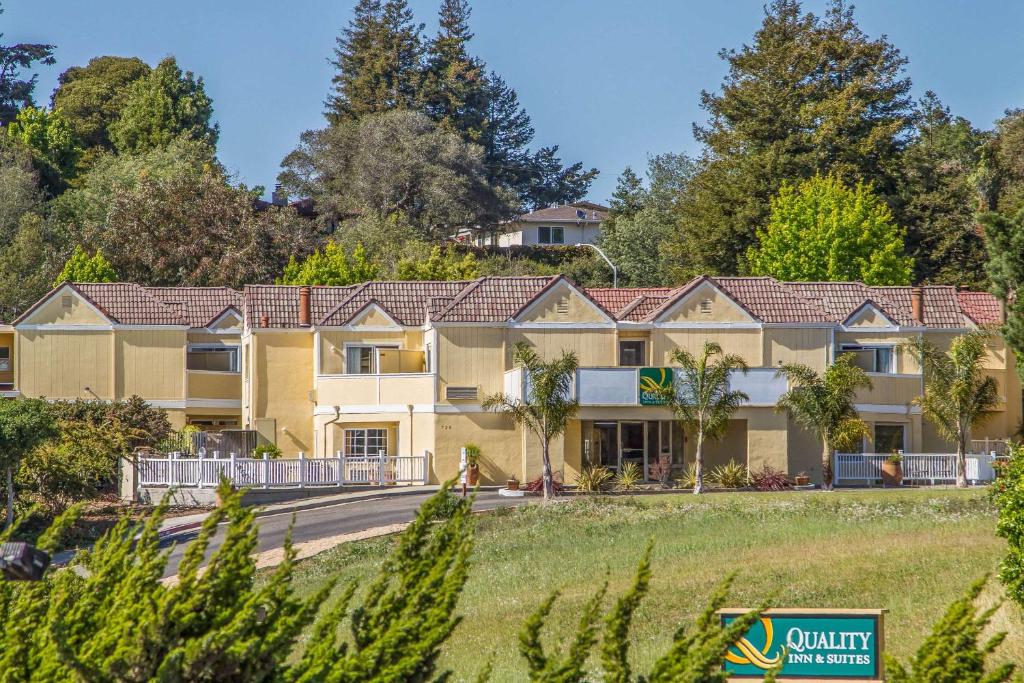 an exterior view of a resort with trees at Quality Inn & Suites Capitola By the Sea in Capitola