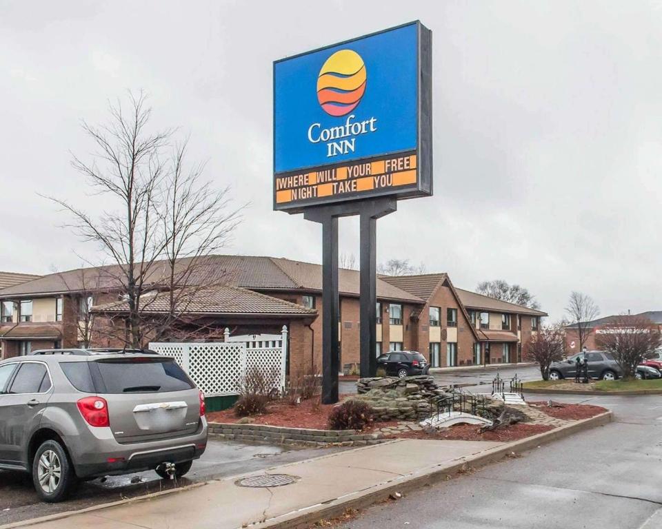 a sign for a car dealership in a parking lot at Comfort Inn in Pembroke