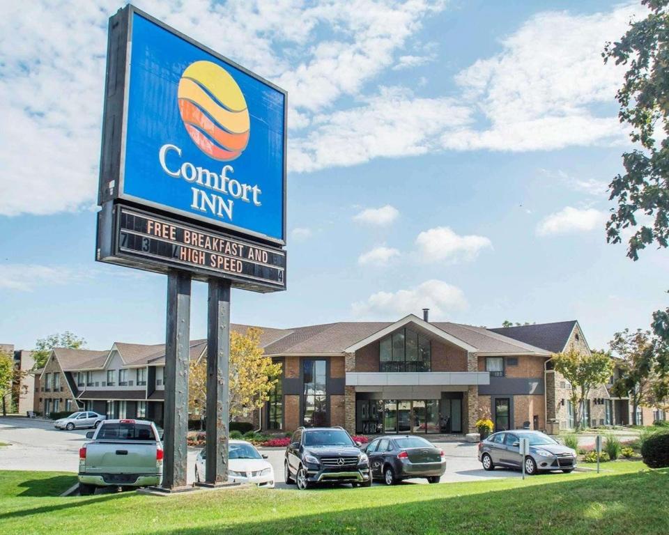 a sign for a comfort inn in front of a parking lot at Comfort Inn Burlington in Burlington