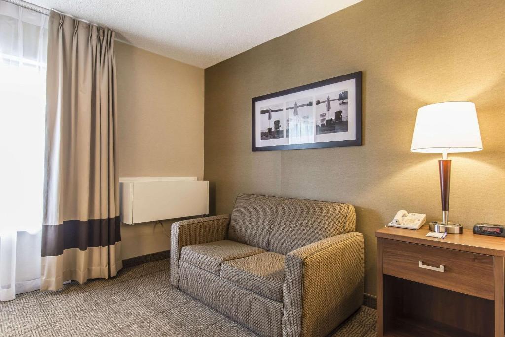a room with a chair and a lamp and a phone at Comfort Inn in Huntsville