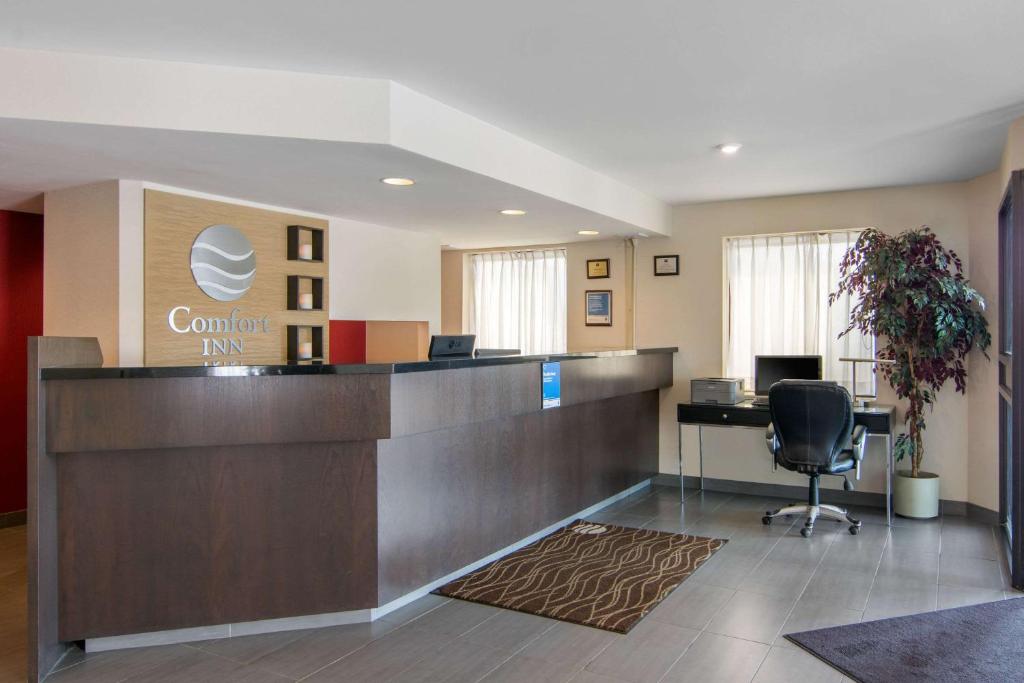 an office lobby with a reception desk and a computer at Comfort Inn Sudbury in Sudbury