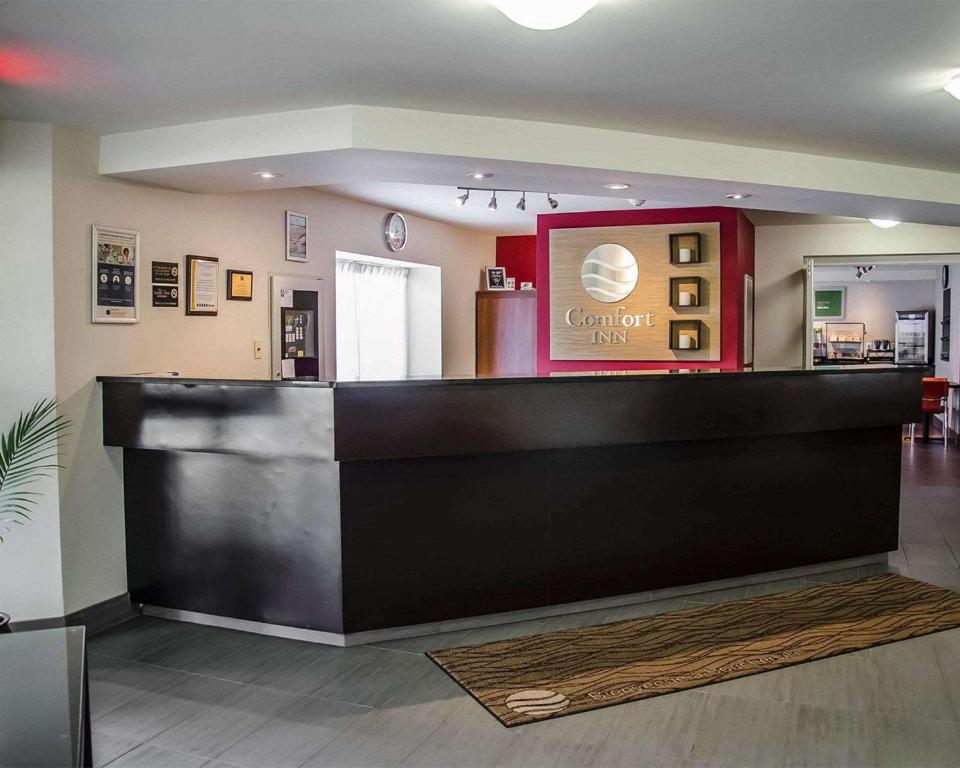 a lobby of a coffee shop with a counter at Comfort Inn Boucherville in Boucherville