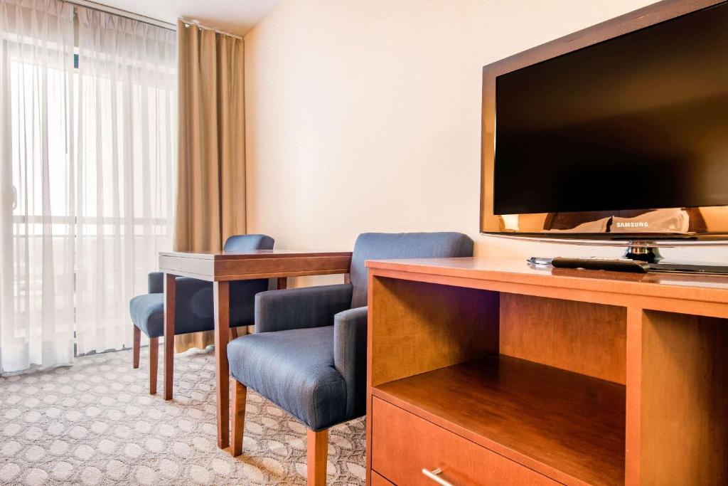 a hotel room with a flat screen tv and a desk at Comfort Inn Fallsview in Niagara Falls