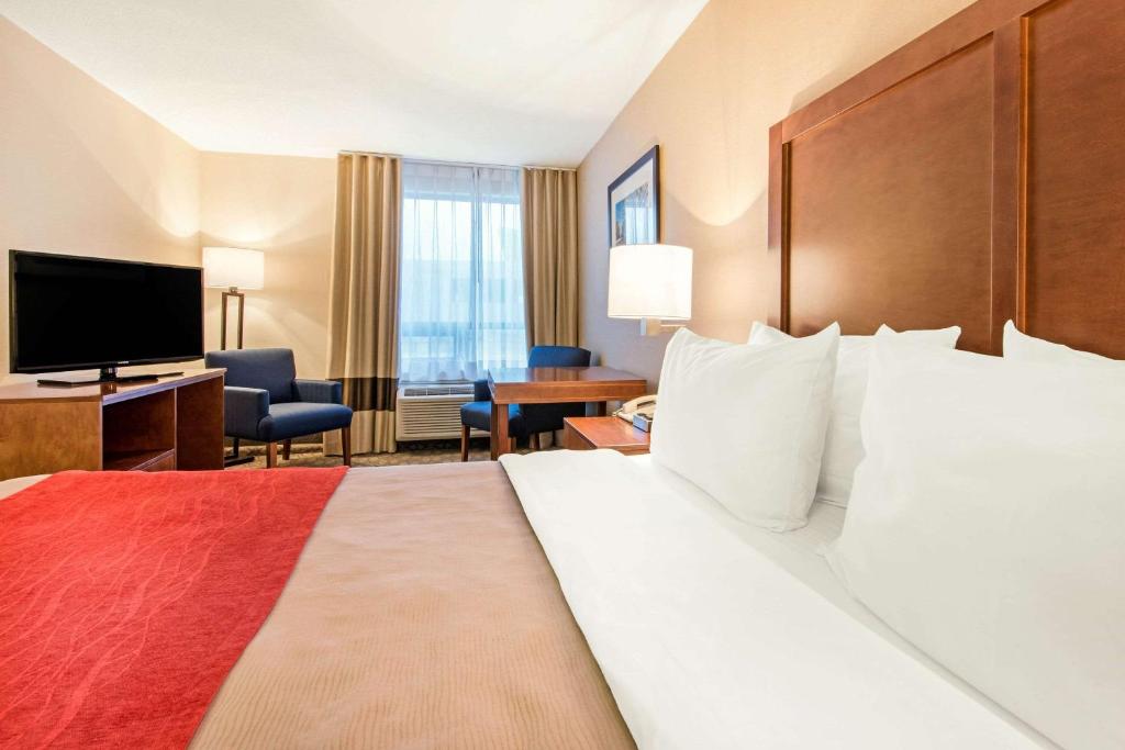 a hotel room with a bed and a flat screen tv at Comfort Inn Fallsview in Niagara Falls