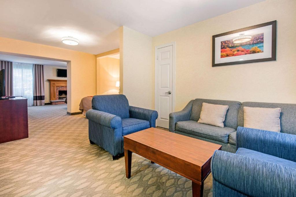 a living room with couches and chairs and a table at Comfort Inn Fallsview in Niagara Falls