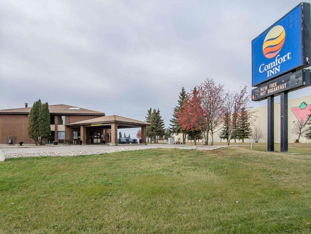 a sign for a car dealership in front of a building at Comfort Inn Prince Albert in Prince Albert