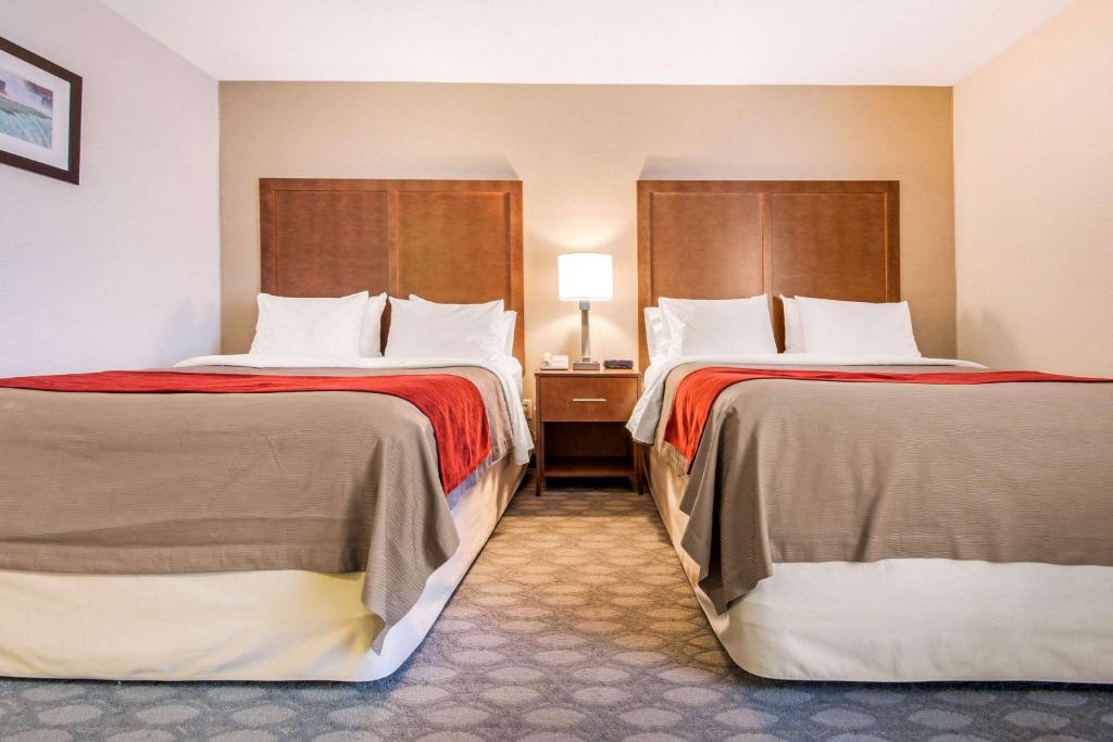 a hotel room with two beds with red sheets at Comfort Inn Fallsview in Niagara Falls