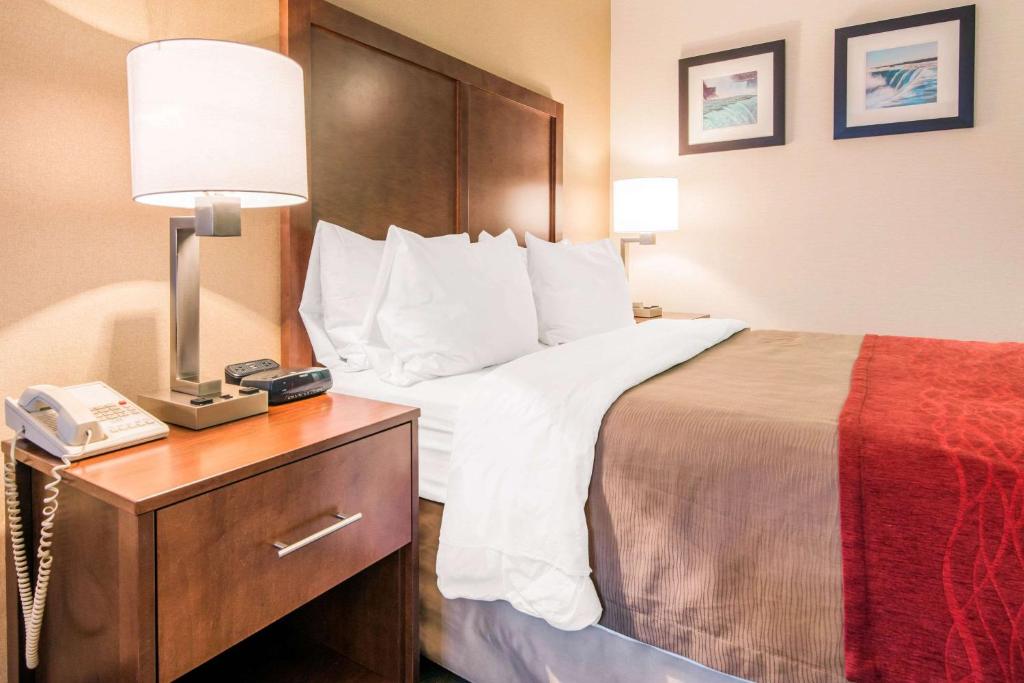 a hotel room with a bed and a telephone at Comfort Inn Fallsview in Niagara Falls
