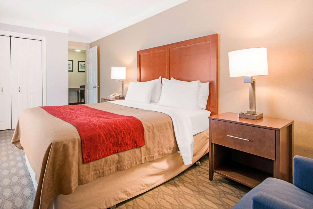 a hotel room with a large bed and a chair at Comfort Inn Fallsview in Niagara Falls