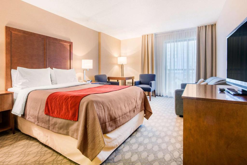 a hotel room with a bed and a television at Comfort Inn Fallsview in Niagara Falls