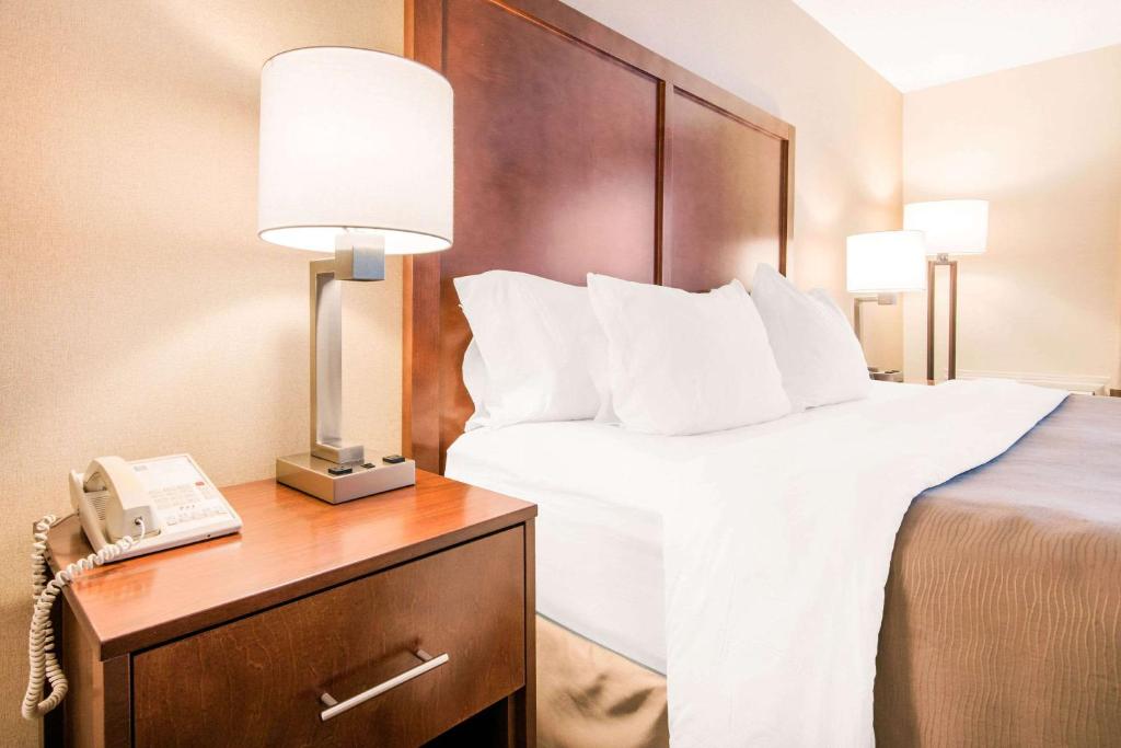 a hotel room with a bed and a telephone at Comfort Inn Fallsview in Niagara Falls