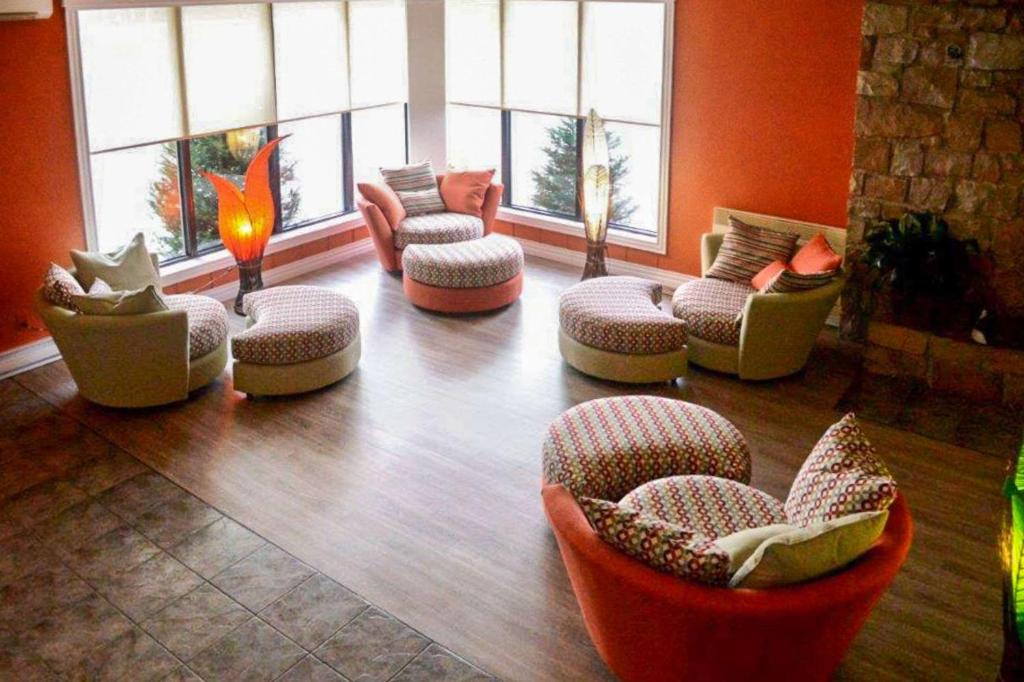 a lobby with couches and chairs in a room at Rodeway Inn in Grand Falls