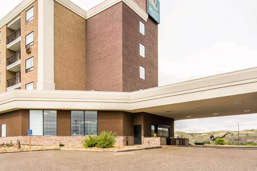 a large brick building with a sign on it at Quality Hotel Drumheller in Drumheller