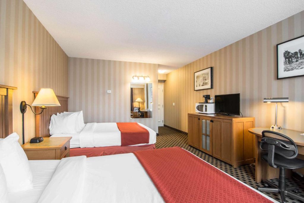 Postel nebo postele na pokoji v ubytování Quality Hotel
