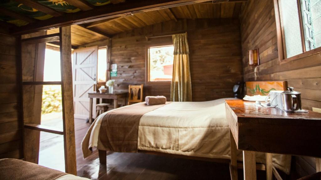 Postel nebo postele na pokoji v ubytování Paraíso Quetzal Lodge
