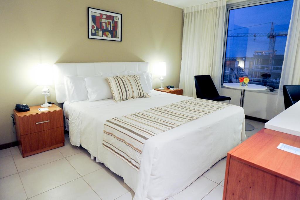 Postel nebo postele na pokoji v ubytování Real Colonia Hotel & Suites