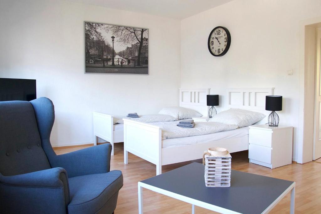 a living room with a bed and a couch and a table at Cosy Apartment Neuss in Neuss