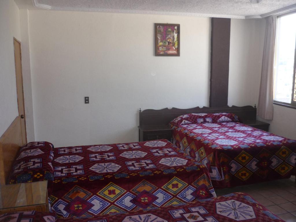 Postel nebo postele na pokoji v ubytování Hotel Primavera
