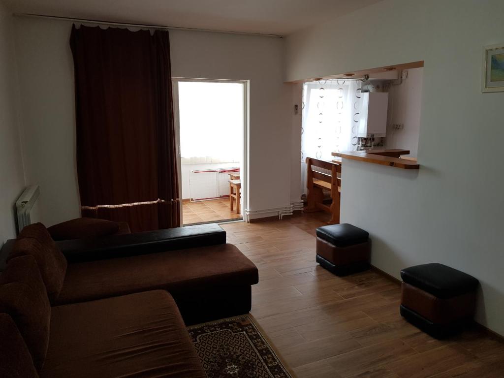 sala de estar con sofá, mesa y cocina en Apartament Delfinariu-Constanta, en Constanţa