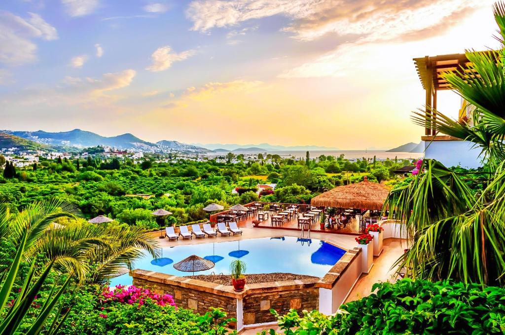 a view of a resort with a pool and a city at 4reasons hotel + bistro | 12+ in Yalıkavak