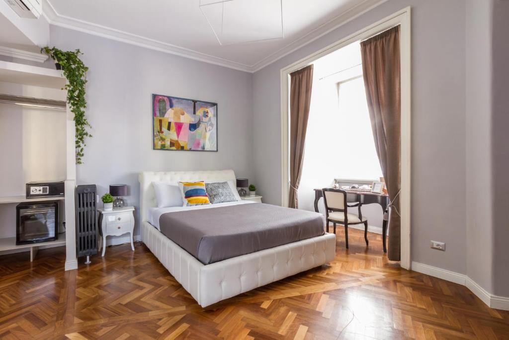 a bedroom with a bed and a table in a room at Athena Guest House in Rome